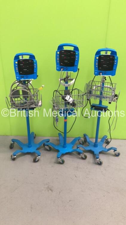 3 x GE ProCare Vital Signs Monitors on Stands with 3 x SPO2 Finger Sensors and 2 x BP Hoses (All Power Up)