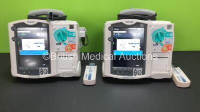 2 x Philips Heartstart MRx Defibrillators Including ECG and Printer Options with 2 x Paddle Leads and 2 x Philips M3725A Test Loads 2 x M3539A Modules and 2 x Philips M3538A Batteries *Mfd 2011 - 2011* (Both Power Up)