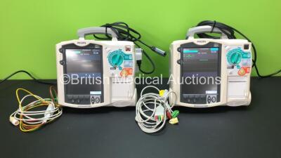 2 x Philips Heartstart MRx Defibrillators Including 1 x Pacer, 2 x ECG and Printer Option with 2 x Philips M3539A Batteries, 2 x Philips M3538 Module, 2 x ECG Leads and 2 x Paddle Lead (Both Power Up) *SN US00534795 - US00214786*