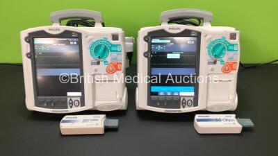 2 x Philips Heartstart MRx Defibrillators Including Pacer, ECG and Printer Option with 2 x Philips M3539A Batteries, 2 x Philips M3538 Module and 2 x Paddle Leads with Test Loads *Mfd 2013-2012* (Both Power Up) *SN US00558693 - US00570196*