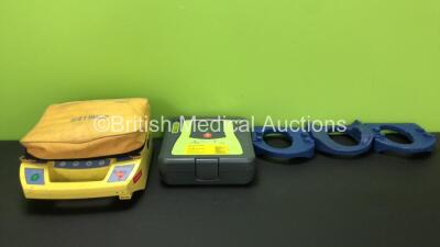 Mixed Lot Including 1 x Zoll AED PRO Defibrillator in Carry Case (Powers Up with Damage when Tested with Stock Battery-Battery Not Included) 3 x LSU Cup Holders and 1 x Schiller FRED First Responder External Defibrillator (Untested Due to Missing Battery-