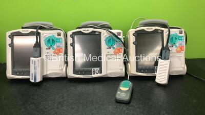 3 x Philips Heartstart MRx Defibrillators Including ECG and Printer Options, 3 x Philips M3538A Batteries, 3 x Philips M3539A Modules, 3 x Paddle Leads and 3 x Philips M3725A 50 Ohm Test Loads (All Power Up)