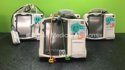 4 x Philips Heartstart MRx Defibrillators Including Pacer, ECG and Printer Options, 4 x Philips M3538A Batteries, 4 x Philips M3539A Modules, 4 x Paddle Leads and 4 x Philips M3725A 50 Ohm Test Loads (All Power Up)