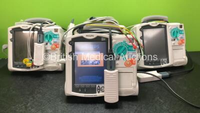 4 x Philips Heartstart MRx Defibrillators Including Pacer, ECG and Printer Options, 4 x Philips M3538A Batteries, 4 x Philips M3539A Modules, 4 x Paddle Leads and 4 x Philips M3725A 50 Ohm Test Loads and 4 x 3 Lead ECG Leads (All Power Up)