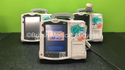 3 x Philips Heartstart MRx Defibrillators Including Pacer, ECG and Printer Option, with 3 x Philips M3539A Batteries, 3 x Philips M3538 Module and 3 x Paddle Leads with Test Loads *Mfd 2013-2012* (All Power Up) *SN US00558693 - US00570196 - US00331303*