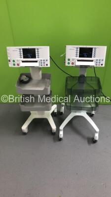 2 x Huntleigh Sonicaid FM800 Encore Fetal Monitors on Stands (Both Power Up - 1 Missing Wheel - 1 x Damaged Port - See Pictures) *S/N 751DX01 00123-09 / 751DX0501471-13*