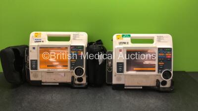 2 x Medtronic Lifepak 12 Biphasic Defibrillators / Monitors Including ECG, SPO2, CO2, NIBP and Printer Options with 4 x Batteries and 1 x Carry Cases (Both Power Up, One with Service Light-See Photo) *SN 37797928, 37628564*