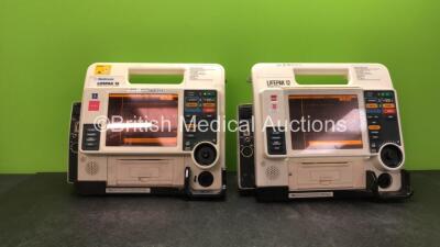 2 x Medtronic Lifepak 12 Biphasic Defibrillators / Monitors Including ECG, SPO2, CO2, NIBP and Printer Options with 4 x Batteries (Both Power Up) *SN 37808480, 37620271*