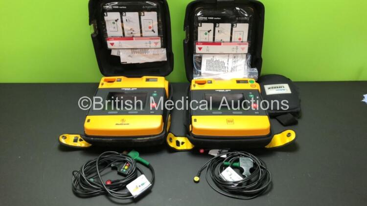 2 x Lifepak 1000 Defibrillators with 2 x 3 Lead ECG Leads and Cases (Both Power Up wth Stock Batteries - Not Included) *39940054 - 38378796*
