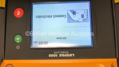 2 x Lifepak 1000 Defibrillators with 2 x 3 Lead ECG Leads and Cases (Both Power Up wth Stock Batteries - Not Included) *39940054 - 38378796* - 3