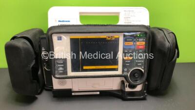 Medtronic Lifepak 12 Biphasic Defibrillator / Monitors Including ECG, SPO2, NIBP and Printer Options with 1 x Carry Case and 1 x Battery *Mfd 2002* (Powers Up with Some Damage to Casing - See Photo)