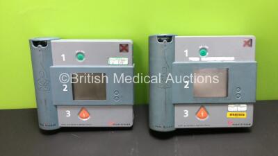 2 x Heartstream Semi Automatic Defibrillators with 2 x Philips Ref BT1 Batteries (1 Powers Up with Alarm and Blank Screen, 1 No Power) *000001231 / 000011830*