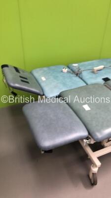 2 x Huntleigh Akron Electric Patient Examination Couches with Controllers (Both Power Up-Damage to Cushions-See Photos) * SN 64141 / 642142 * - 2