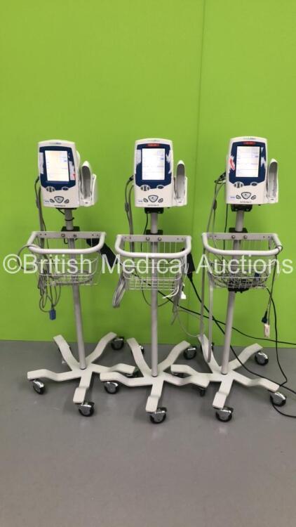 3 x Welch Allyn Spot Vital Signs LXi Monitors on Stands and 3 x BP Hoses and 3 x SpO2 Finger Sensors (All Power Up)