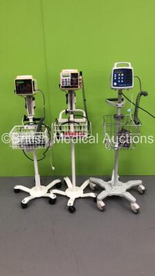 2 x Criticare ComfortCuff Patient Monitors on Stands with 2 x BP Hoses,2 x BP Cuffs and 2 x SpO2 Finger Sensors and 1 x Criticare Vital Care Patient Monitor on Stand with BP Cuff (All Power Up) * SN 407235532 / 201403125 / N/A *