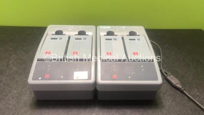 2 x Physio Control Ref 11141-000107 Station Li-ion Battery Chargers with 4 x Physio Control Ref 21330-001176 Li-ion Rechargeable Batteries (Both Power Up) *SN LP15S02754, LP15S03678*