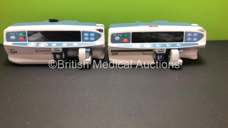 2 x Alaris GH Infusion Pumps (1 x Carefusion, 1 x Cardinal Health) Both Draw Power with 1 x Missing Casing Part - See Photo