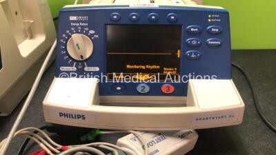 1 x Philips Heartstart XL Smart Biphasic Defibrillators Including Pacer, ECG and Printer Options and 1 x Philips Heartstart XL Smart Biphasic Defibrillators Including ECG and Printer Options with 2 x Paddle Leads, 2 x Philips M3725A Test Loads and 2 x 3 - 4