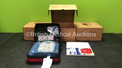 3 x Philips Heartstart HS1 Defibrillators with 3 x Philips Ref M5070A Batteries *Install Dates - 11-2026, 11-2026, 11-2026* with 3 x Philips M5071A Smart Pads Cartridge *Use By Dates- 07-2023. 07-2023, 07-2023* (All Power Up and Boxed in Excellent Conditi