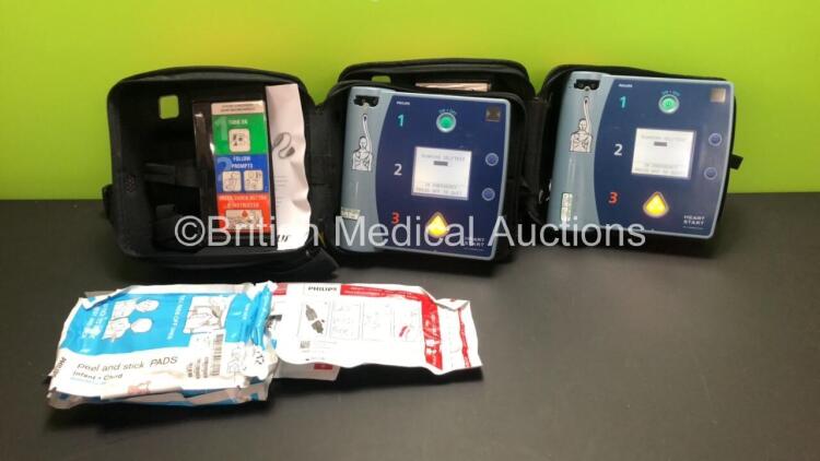 2 x Philips Heartstart FR2+ Defibrillators in Carry Cases with 2 x Batteries *Install Dates 09-2022 / 09-2023* (Both Power Up and Pass Self Test) *0203085838 - 0911891444*