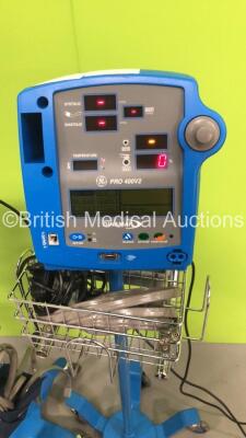 3 x GE Dinamap Pro 400V2 Patient Monitors on Stands with 2 x BP Hoses,3 x BP Cuffs and 1 x SpO2 Finger Sensor and 1 x GE ProCare Patient Monitor on Stand (All Power Up-1 x Missing Dial and Side Panel-See Photos) * SN AAW06500225SA / AAX071003SA / AAX07420 - 5