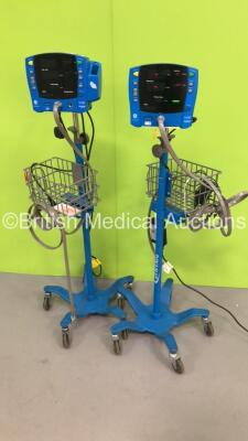 2 x GE Dinamap Carescape V100 Vital Signs Monitors on Stands with BP Hoses (Both Power Up)