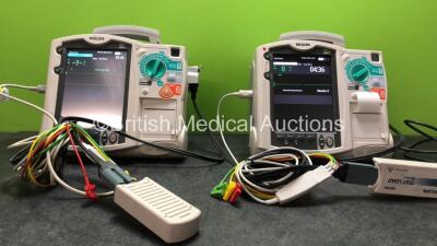 2 x Philips MRx Defibrillators Including Pacer, ECG and Printer Options with 2 x Philips M3539A Power Adapters and 2 x Philips M3538A Batteries 2 x Paddle Lead, 2 x Philips M3725A Test Loads and 2 x 3 Lead ECG Leads (Both Power Up)