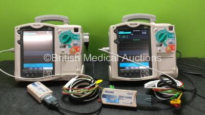 2 x Philips MRx Defibrillators Including Pacer, ECG and Printer Options with 2 x Philips M3539A Power Adapters and 2 x Philips M3538A Batteries 2 x Paddle Lead, 2 x Philips M3725A Test Loads and 2 x 3 Lead ECG Leads (Both Power Up)