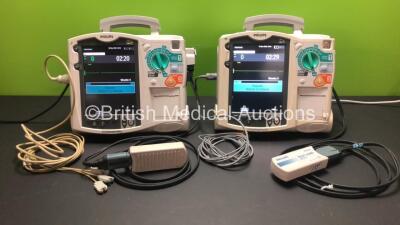 2 x Philips MRx Defibrillators Including Pacer, ECG and Printer Options with 2 x Philips M3539A Power Adapters and 2 x Philips M3538A Batteries 2 x Paddle Lead, 2 x Philips M3725A Test Loads and 2 x 3 Lead ECG Leads (Both Power Up)