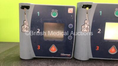 Mixed Lot Including 2 x Laerdal Heartstart FR2 Defibrillators (1 No Power, 1 Powers Up with Blank Display- Batteries Not Included) 1 x Physio Control Lifepak 5 Battery Charger (Powers Up) - 2