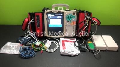 Philips Heartstart MRx Defibrillator Including ECG, CO2, NIBP, SpO2 and Printer Options *Mfd 2010* with Side Bags Containing 3 x M3538A Batteries, 1 x ECG Lead, 1 x SpO2 Lead, 1 x BP Lead with Cuff, 1 x Paddle Lead, 1 x Laerdal Q-CPR Meter and Electrode P