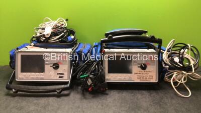 2 x Zoll E Series Defibrillators Including ECG, SpO2, CO2, NIBP and Printer Options, 2 x SpO2 Finger Sensors, 2 x Paddle Leads, 2 x NIBP Hoses and 1 x BP Cuff (Both Untested Due to Missing Batteries)