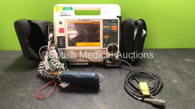 Medtronic Lifepak 12 Biphasic Defibrillator Including ECG, SpO2, NIBP, CO2 and Printer Options with 2 x Lifepak NiCd Batteries, 1 x NIBP Hose, 1 x BP Cuff, 1 x SpO2 Finger Sensor and 1 x Paddle Lead (Powers Up) *SN 37628554*