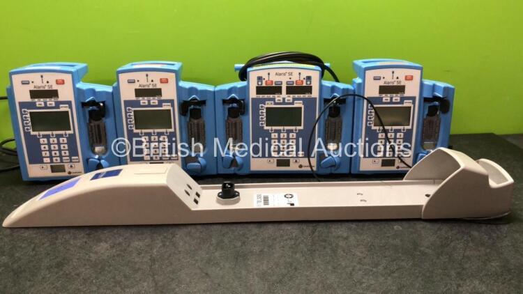 Mixed Lot Including 4 x Alaris SE Pumps (1 Powers Up, 2 No Power, 1 Powers Up with Maintenance Message) 1 x Arjo Ref 70024250 Hoist Battery Charger (Powers Up)