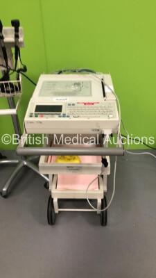 1 x Agilent PageWriter 200 ECG Machine on Stand with 10 Lead ECG Leads, 1 x Welch Allyn Otoscope / Ophthalmoscope Set on Stand with 2 x Handpieces and 1 x Head (See Pictures) and 3 x Blood Pressure Meters on Stands - 2