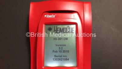 Mixed Lot Including 5 x HemoCue Hb 201 DM Blood Analysers with Docking Stations (All Power Up) 10 x Covidien Genius 3 Tympanic Thermometers and 1 x Roche CoaguChek S Coagulation Meter with Power Supply and Case (Powers Up) 1302621083 - 1302621081 - 130262 - 2