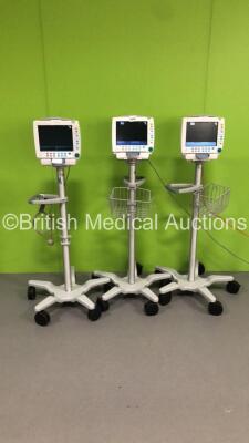 3 x GE S5 F-FM-00 Patient Monitors on Stands (All Power Up-All Chips to Casing-See Photos) * SN 6577677 / 6577659 / 6577666 * * Mfd 2009 / 2009 / 2009 *