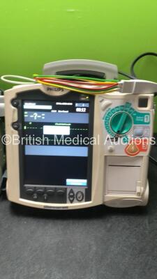 2 x Philips MRx Defibrillators Including ECG and Printer Options with 2 x Philips M3539A Power Adapters 2 x Paddle Lead, and 2 x 3 Lead ECG Leads (Both Power Up) *US00546549, US0054659* - 2