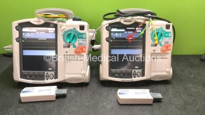 2 x Philips MRx Defibrillators Including Pacer,ECG and Printer Options with 2 x Philips M3539A Power Adapters, 2 x Philips M3538A Batteries, 2 x Paddle Lead, 2 x Philips M3725A Test Loads and 2 x 3 Lead ECG Leads (Both Power Up) *US00585183, US00546520*