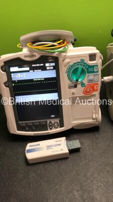 2 x Philips MRx Defibrillators Including Pacer,ECG and Printer Options with 2 x Philips M3539A Power Adapters, 2 x Philips M3538A Batteries, 2 x Paddle Lead, 2 x Philips M3725A Test Loads and 2 x 3 Lead ECG Leads (Both Power Up) *US00585183, US00546520* - 3