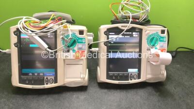 2 x Philips MRx Defibrillators Including Pacer, ECG SpO2 and Printer Options with 2 x Philips M3539A Power Adapters, 2 x Philips M3538A Batteries, 2 x Paddle Lead, and 2 x 3 Lead ECG Leads (Both Power Up) *US00539106, US00546526*
