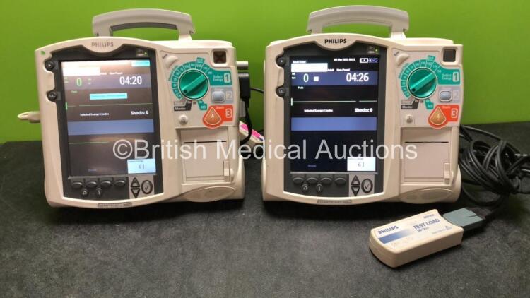 2 x Philips MRx Defibrillators Including Pacer, ECG and Printer Options with 2 x Philips M3539A Power Adapters and 2 x Philips M3538A Batteries, 2 x Paddle Lead, 2 x Philips M3725A Test Loads and 1 x 3 Lead ECG Lead (Both Power Up 1 with Device Error-See