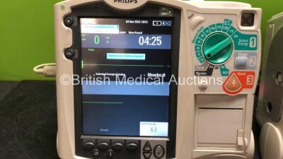 2 x Philips MRx Defibrillators Including Pacer, ECG and Printer Options with 2 x Philips M3539A Power Adapters and 2 x Philips M3538A Batteries, 2 x Paddle Lead, 2 x Philips M3725A Test Loads and 1 x 3 Lead ECG Lead (Both Power Up 1 with Device Error-See - 2