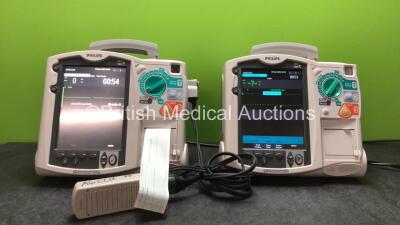 2 x Philips MRx Defibrillators Including Pacer, ECG and Printer Options with 2 x Philips M3539A Power Adapters, 1 x Paddle Lead, 1 x Philips M3725A Test Load (Both Power Up)