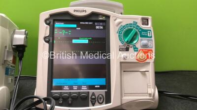 2 x Philips MRx Defibrillators Including Pacer, ECG and Printer Options with 2 x Philips M3539A Power Adapters, 1 x Paddle Lead, 1 x Philips M3725A Test Load (Both Power Up) - 2