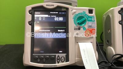 2 x Philips MRx Defibrillators Including Pacer, ECG and Printer Options with 2 x Philips M3539A Power Adapters, 1 x Paddle Lead, 1 x Philips M3725A Test Load (Both Power Up) - 3