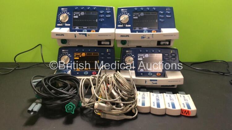 4 x Philips Heartstart XL Smart Biphasic Defibrillators with ECG and Printer Options, 4 x Test Loads, 4 x Paddle Leads, 4 x 3 Lead ECG Leads and 4 x Batteries (All Power Up) *US00122134 / US00448295 / US00116839 / US00588708*