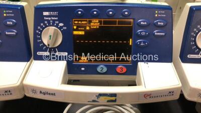 4 x Agilent Heartstream XL Smart Biphasic Defibrillators with ECG and Printer Options, 4 x Test Loads, 4 x Paddle Leads, 4 x 3 Lead ECG Leads and 4 x Batteries (All Powewr Up) *US00103775 - US00110040 - US00110041 - US00110042* - 3