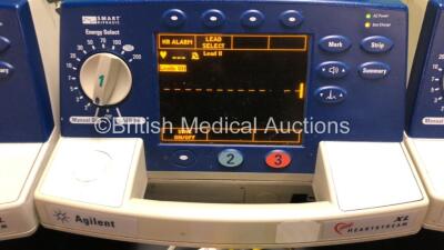 4 x Agilent Heartstream XL Smart Biphasic Defibrillators with ECG and Printer Options, 4 x Test Loads, 4 x Paddle Leads, 4 x 3 Lead ECG Leads and 4 x Batteries (All Powewr Up) *US00103775 - US00110040 - US00110041 - US00110042* - 4