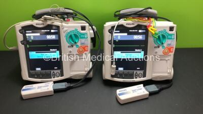 2 x Philips MRx Defibrillators Including ECG and Printer Options with 2 x Philips M3539A Power Adapters and 2 x Philips M3538A Batteries 2 x Paddle Lead, 2 x Philips M3725A Test Loads and 2 x 3 Lead ECG Leads (Both Power Up) *US00546551 - US00546543*